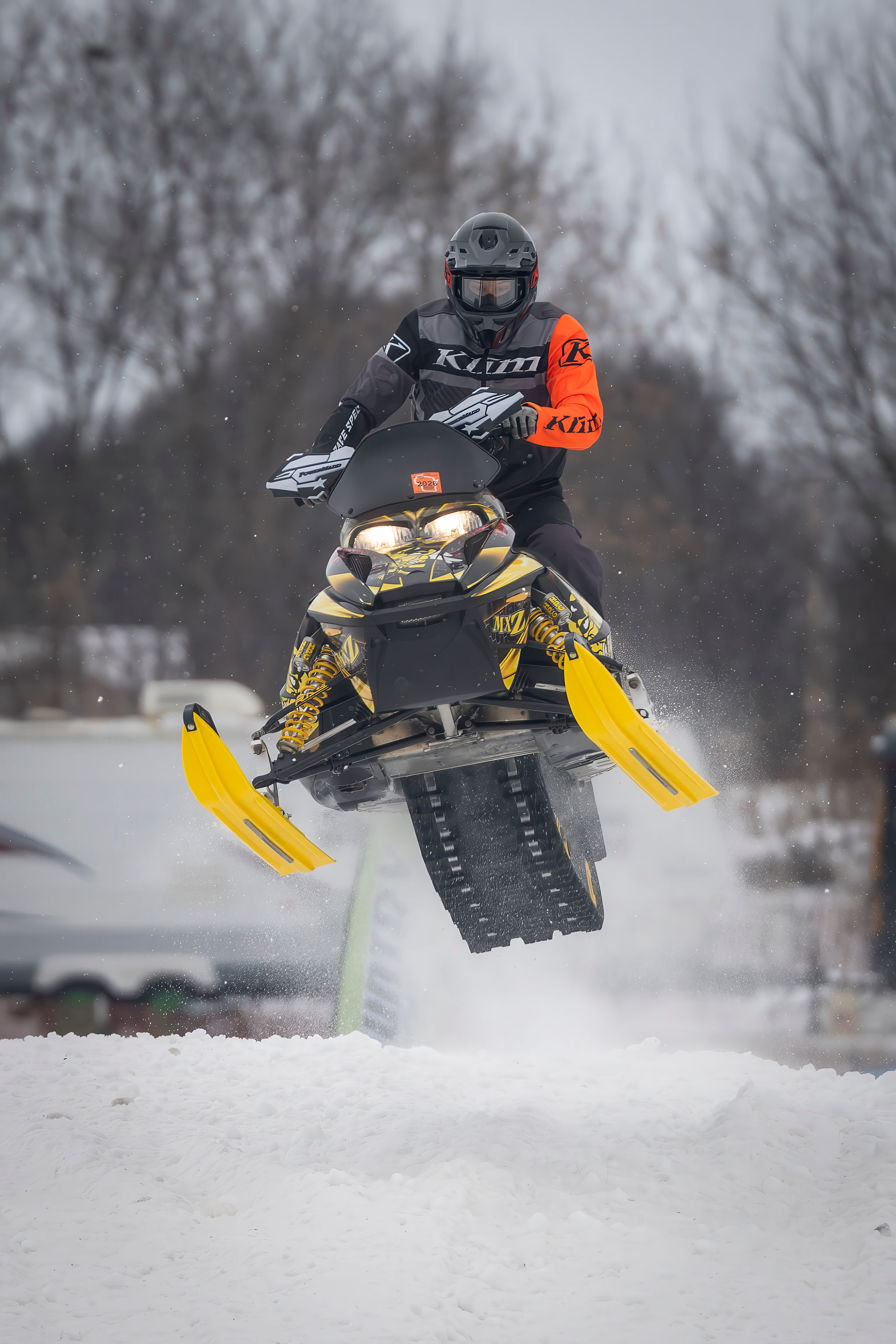 Rider mid-jump on a Ski-Doo MXZ at the RK Compound